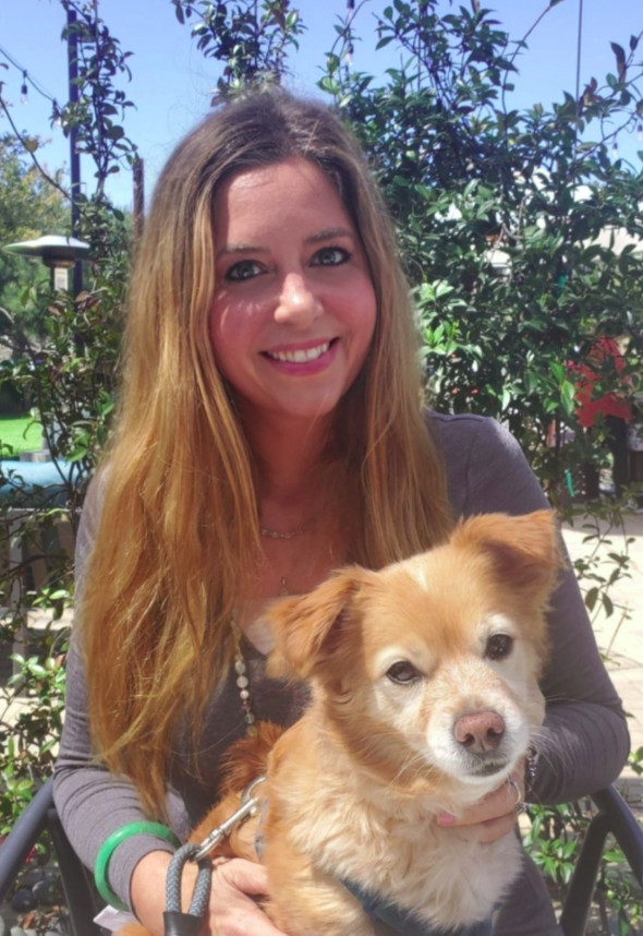 Kate Yen, The Animal Empath, smiling with her golden dog